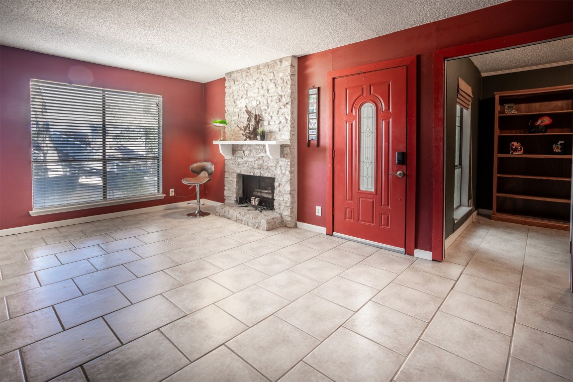 1720 Timber Ridge Drive Austin, TX 78741 - Photo 2 of 30 Good size living room with a large window to view the Austin skylights at night