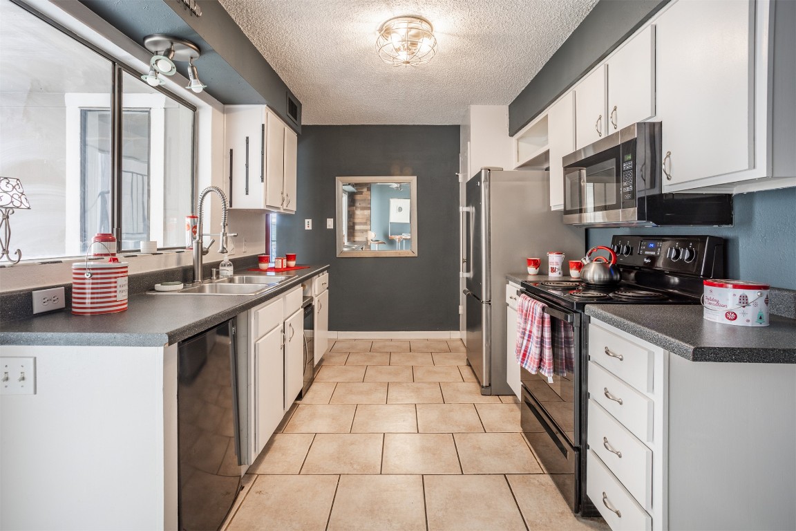 1720 Timber Ridge Drive Austin, TX 78741 - Photo 21 of 30 Nice Kitchen with a good size pantry and a small fridge, refrigerator and wine cooler