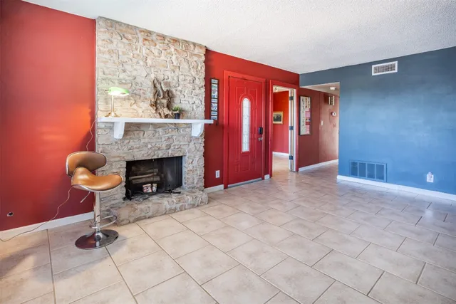a view of an empty room with a fireplace