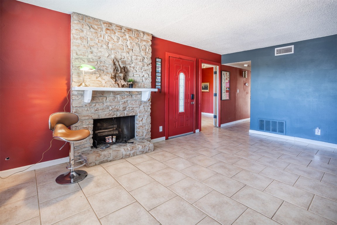 1720 Timber Ridge Drive Austin, TX 78741 - Photo 3 of 30 Family room with wood burning fireplace and front window to see the Austin Skylights