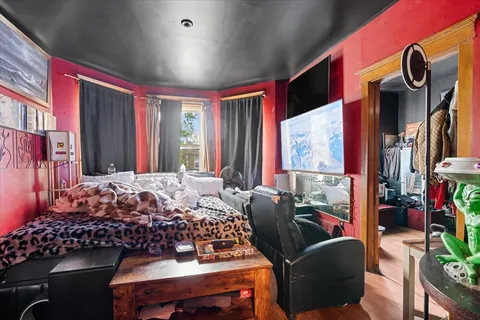 a bedroom with furniture and a window