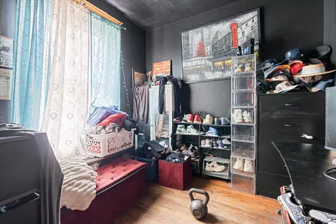 a bedroom with bed and a large window