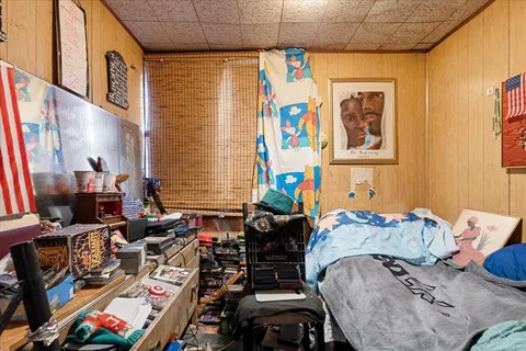 a bed in a bedroom next to a window