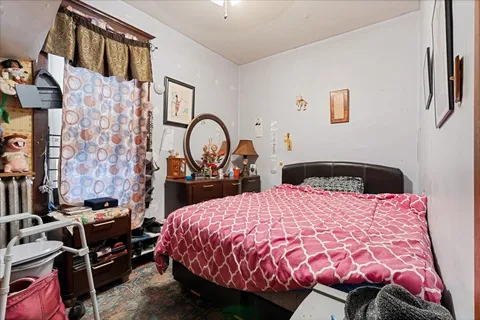 a bed room with a bed and a chair
