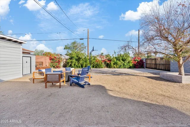 a view of a patio with dining table and chairs and potted plants