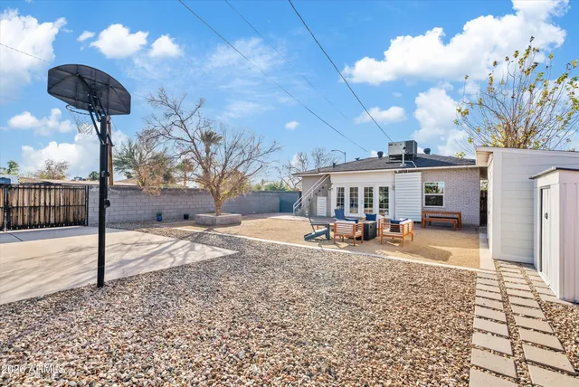 a view of a house with backyard and sitting area