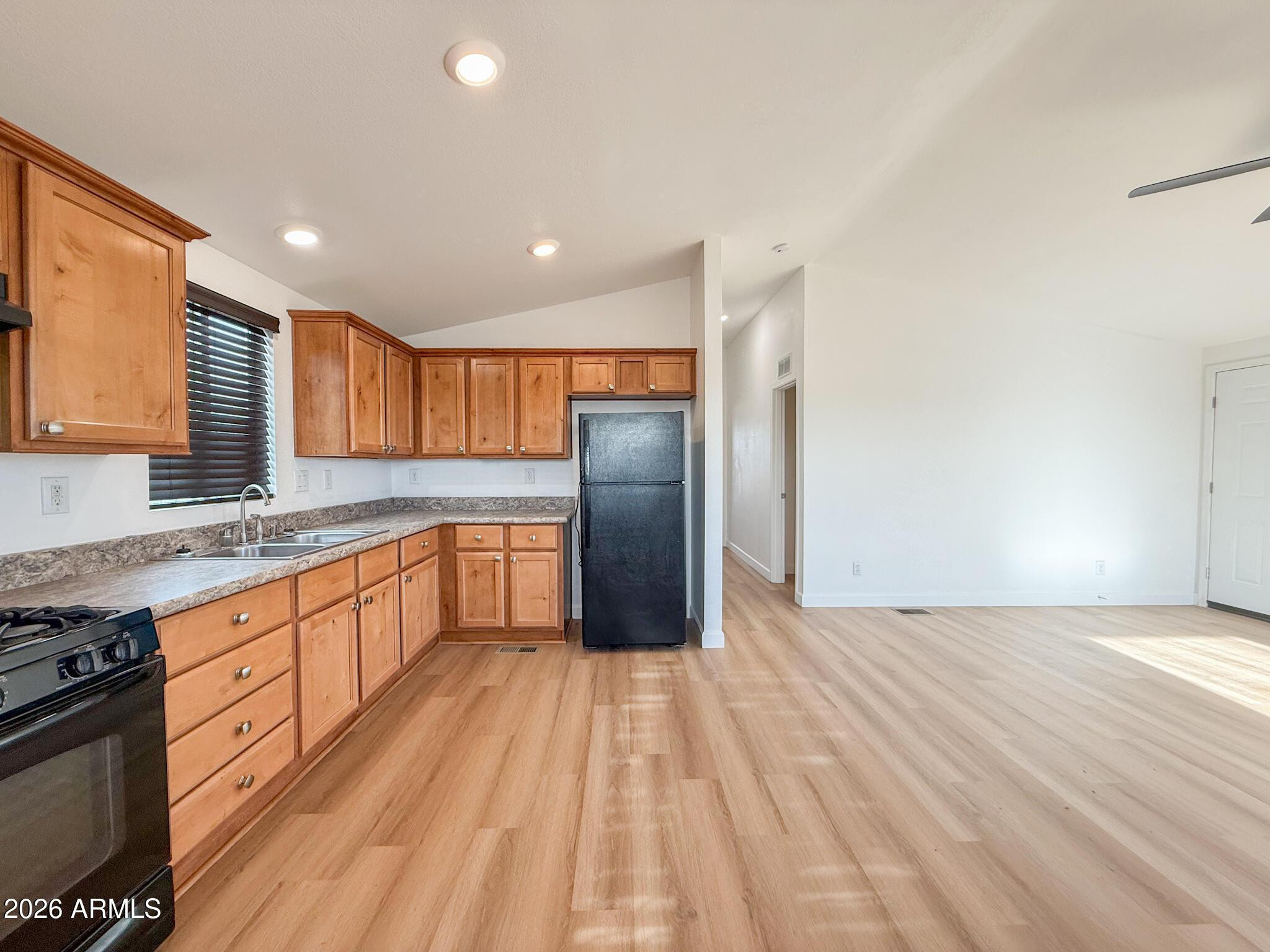 51880 North Gold Plains Road Seligman, AZ 86337 - Photo 10 of 24 a large kitchen with granite countertop a lot of counter space and stainless steel appliances
