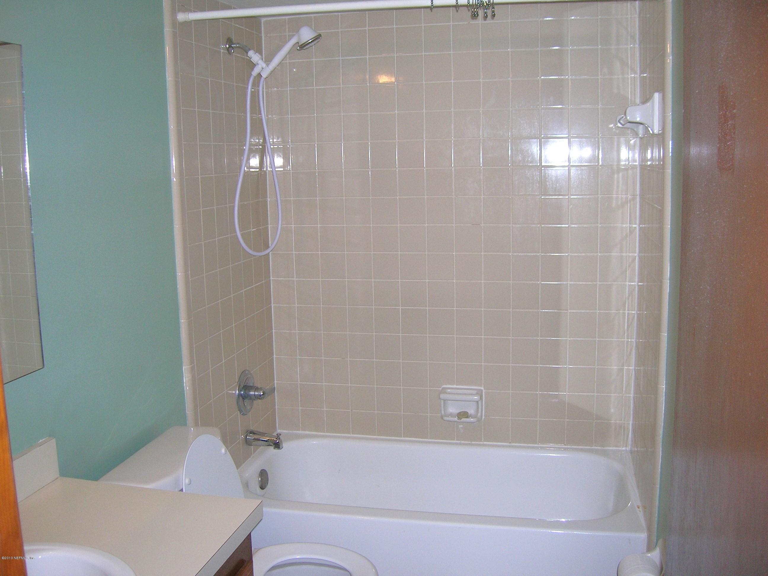 11069 Reading Road Jacksonville, FL 32257 - Photo 11 of 18 a bathroom with a bathtub and a shower