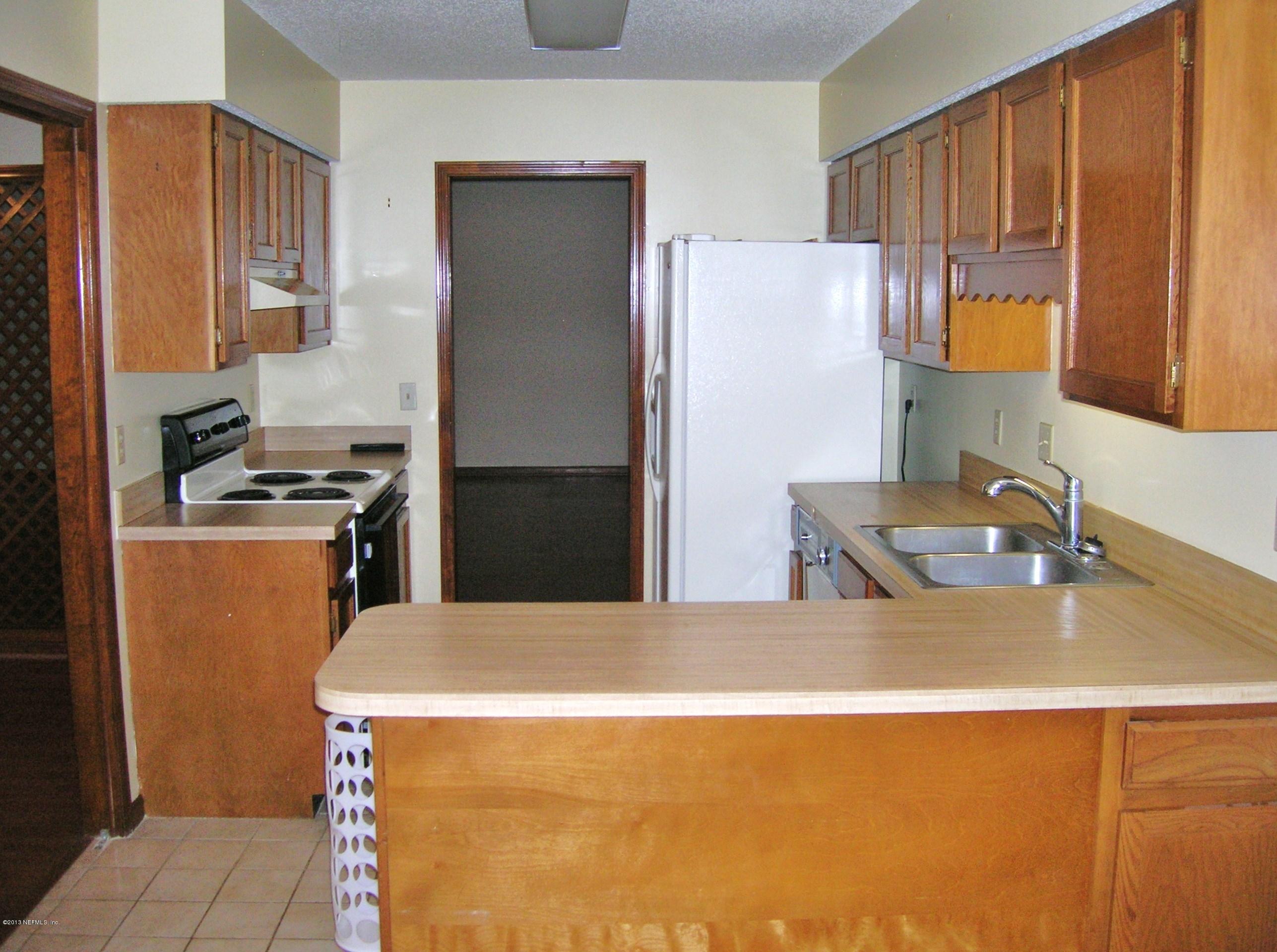 11069 Reading Road Jacksonville, FL 32257 - Photo 3 of 18 a kitchen with stainless steel appliances a refrigerator a sink a stove and white cabinets