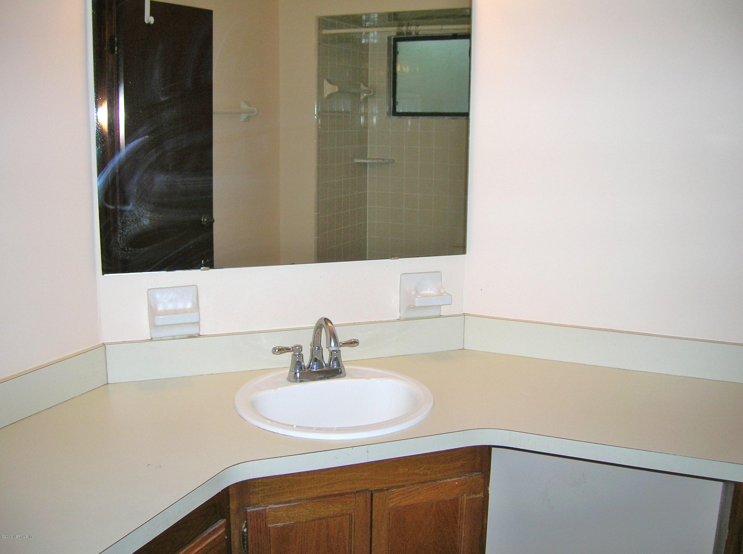 11069 Reading Road Jacksonville, FL 32257 - Photo 9 of 18 a bathroom with a sink and a mirror