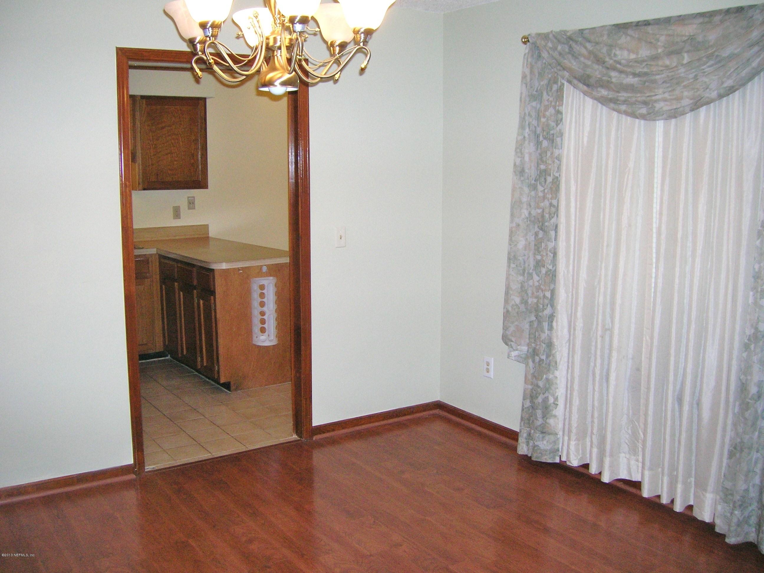 11069 Reading Road Jacksonville, FL 32257 - Photo 10 of 18 a view of a room with wooden floor staircase and a hallway