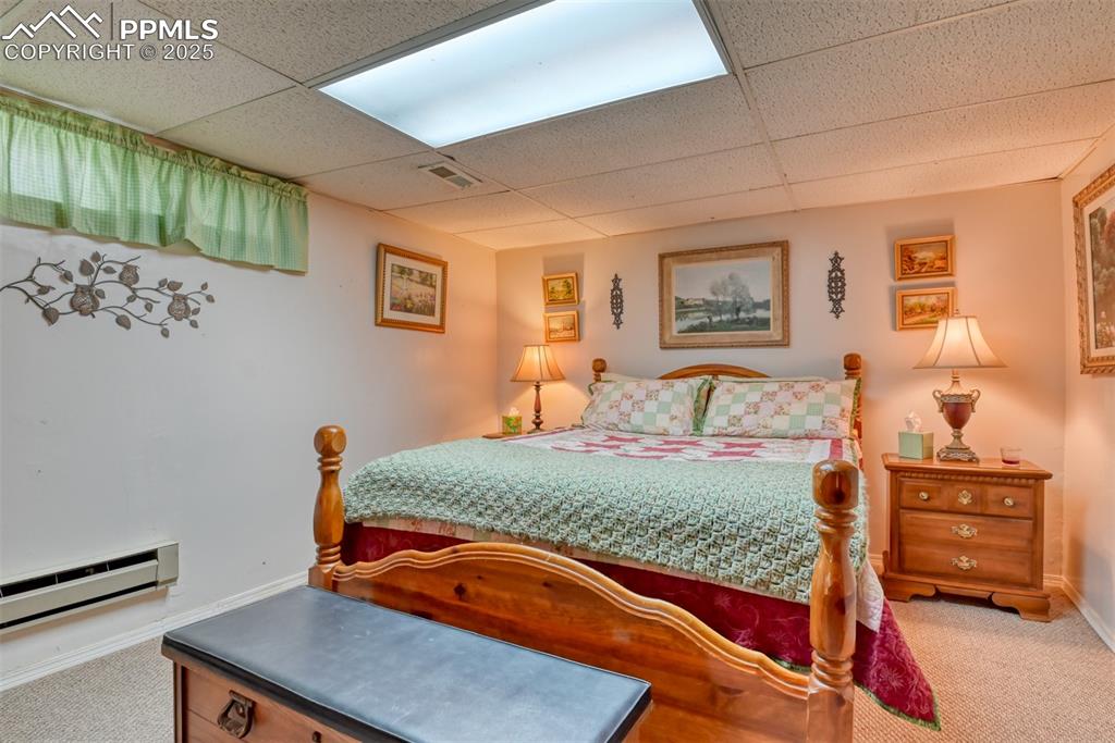 22500 Enoch Road Calhan, CO 80808 - Photo 13 of 29 a bedroom with a bed and dresser