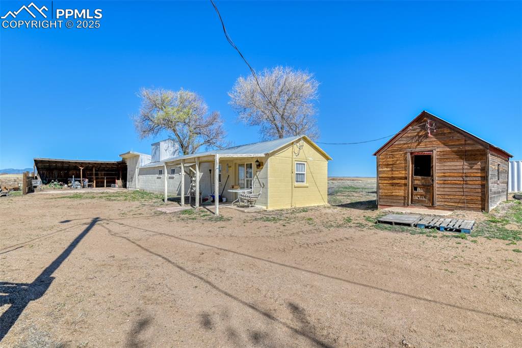 22500 Enoch Road Calhan, CO 80808 - Photo 26 of 29 a view of a house with a yard and garage