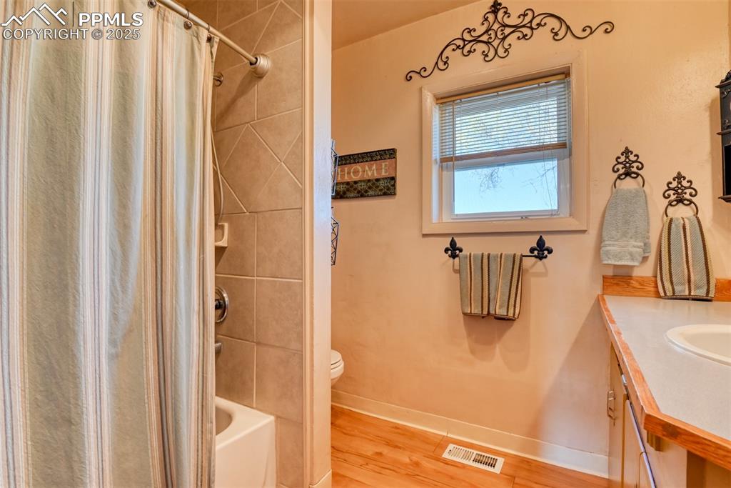 22500 Enoch Road Calhan, CO 80808 - Photo 6 of 29 a bathroom with a sink a mirror and shower