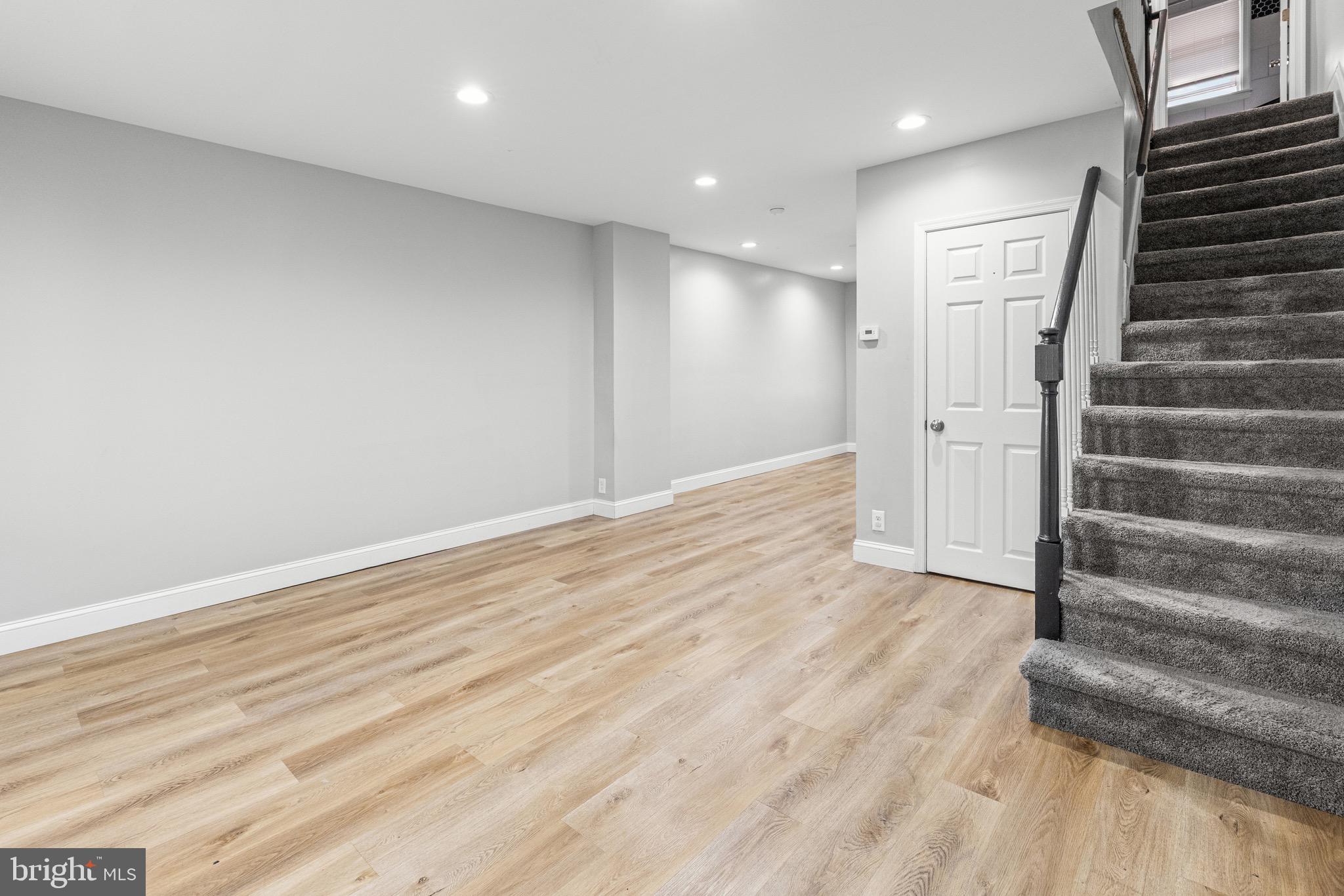 2203 Redthorn Road Baltimore, MD 21220 - Photo 5 of 23 an empty room with wooden floor and windows