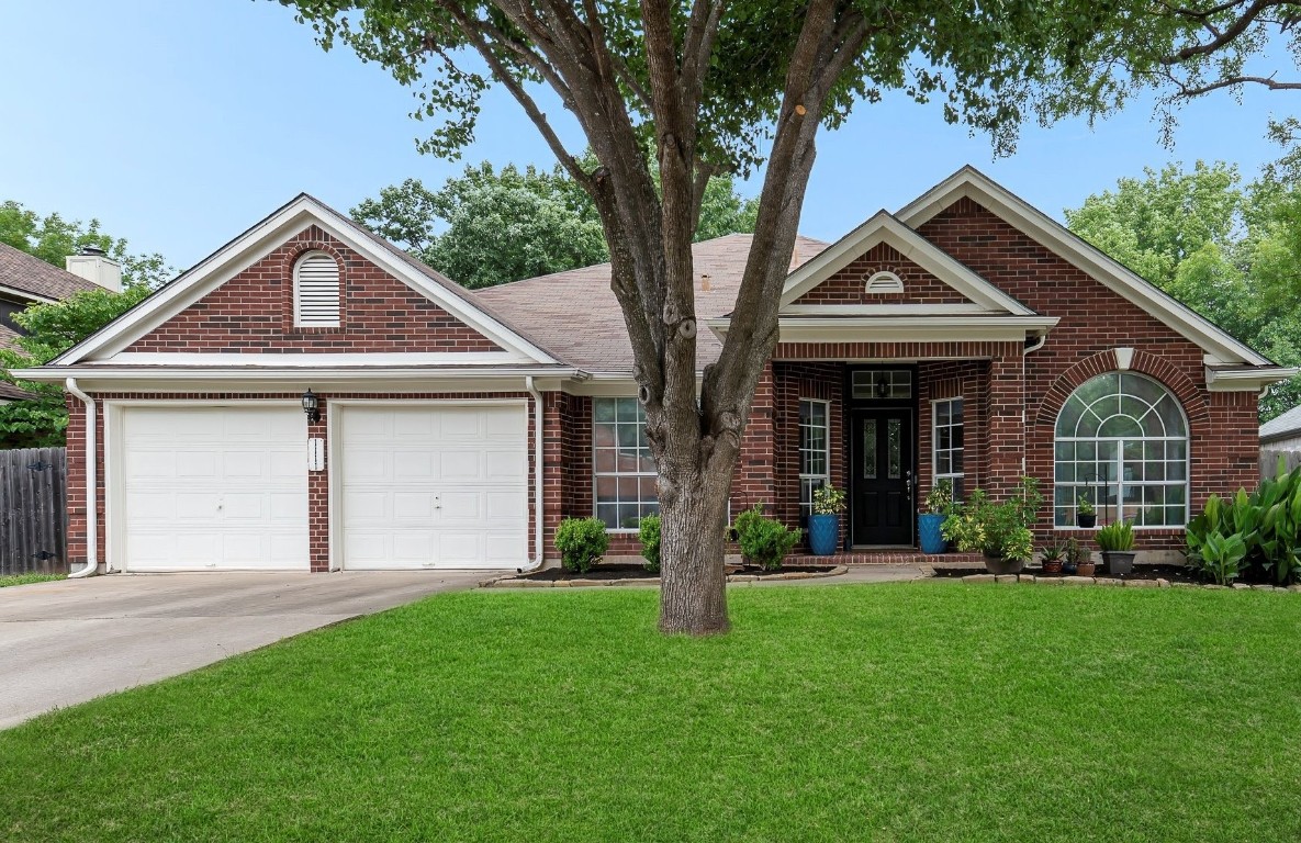 1111 Pebble Brook Road Cedar Park, TX 78613 - Photo 1 of 1 a front view of a house with a yard and garage
