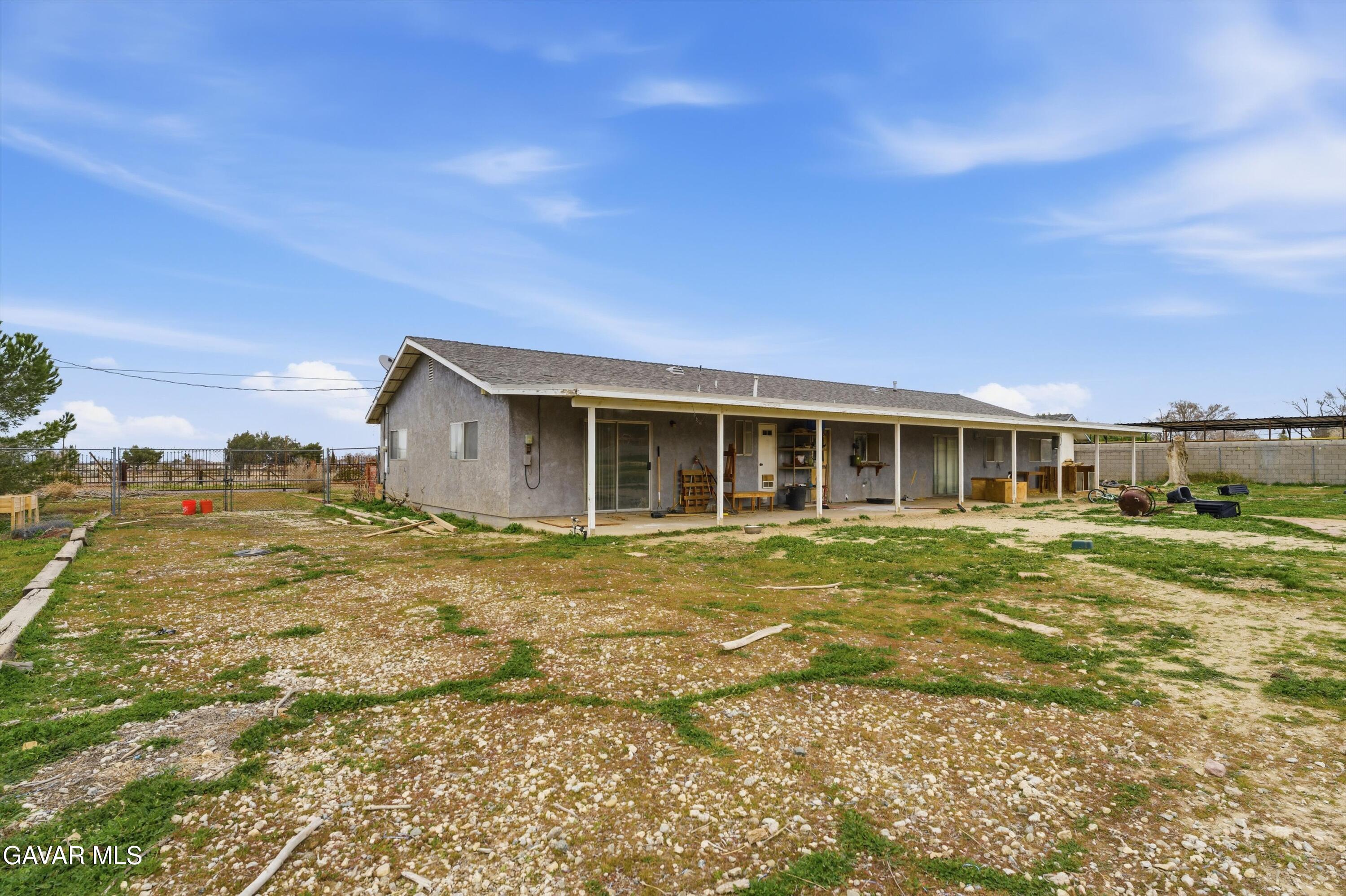 9340 East Ave R 10 Littlerock, CA 93543 - Photo 16 of 33 a front view of a house with a garden