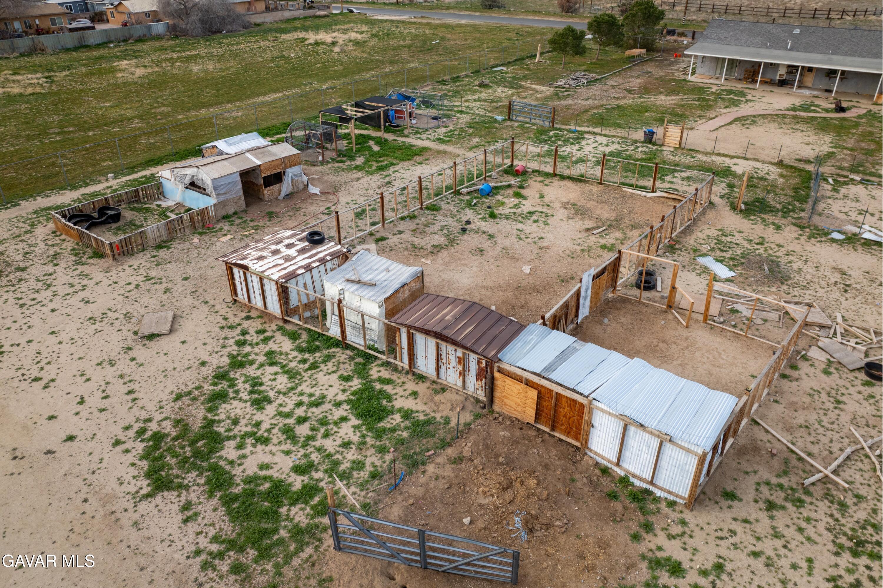 9340 East Ave R 10 Littlerock, CA 93543 - Photo 22 of 33 a view of a lake with lawn chairs and large trees