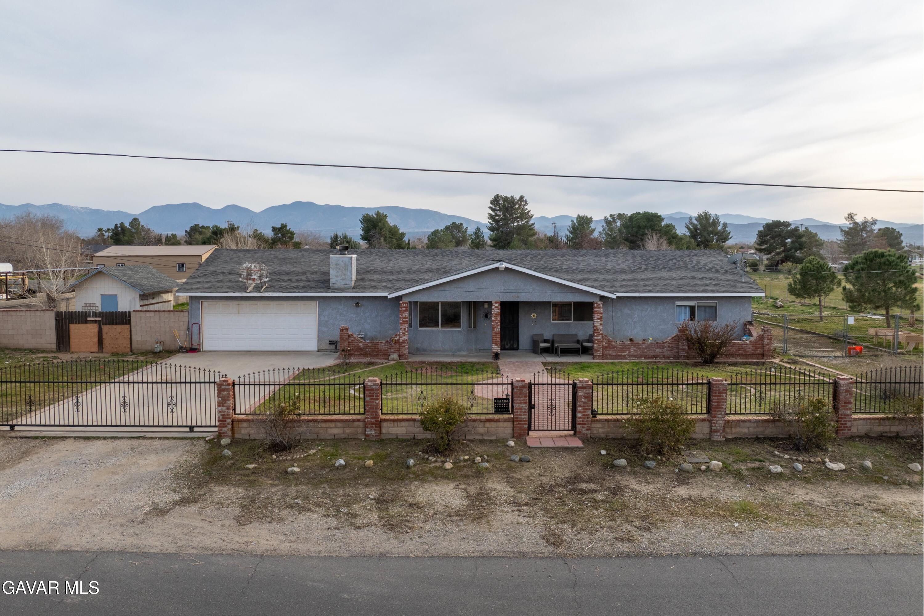 9340 East Ave R 10 Littlerock, CA 93543 - Photo 23 of 33 a front view of a house with a yard