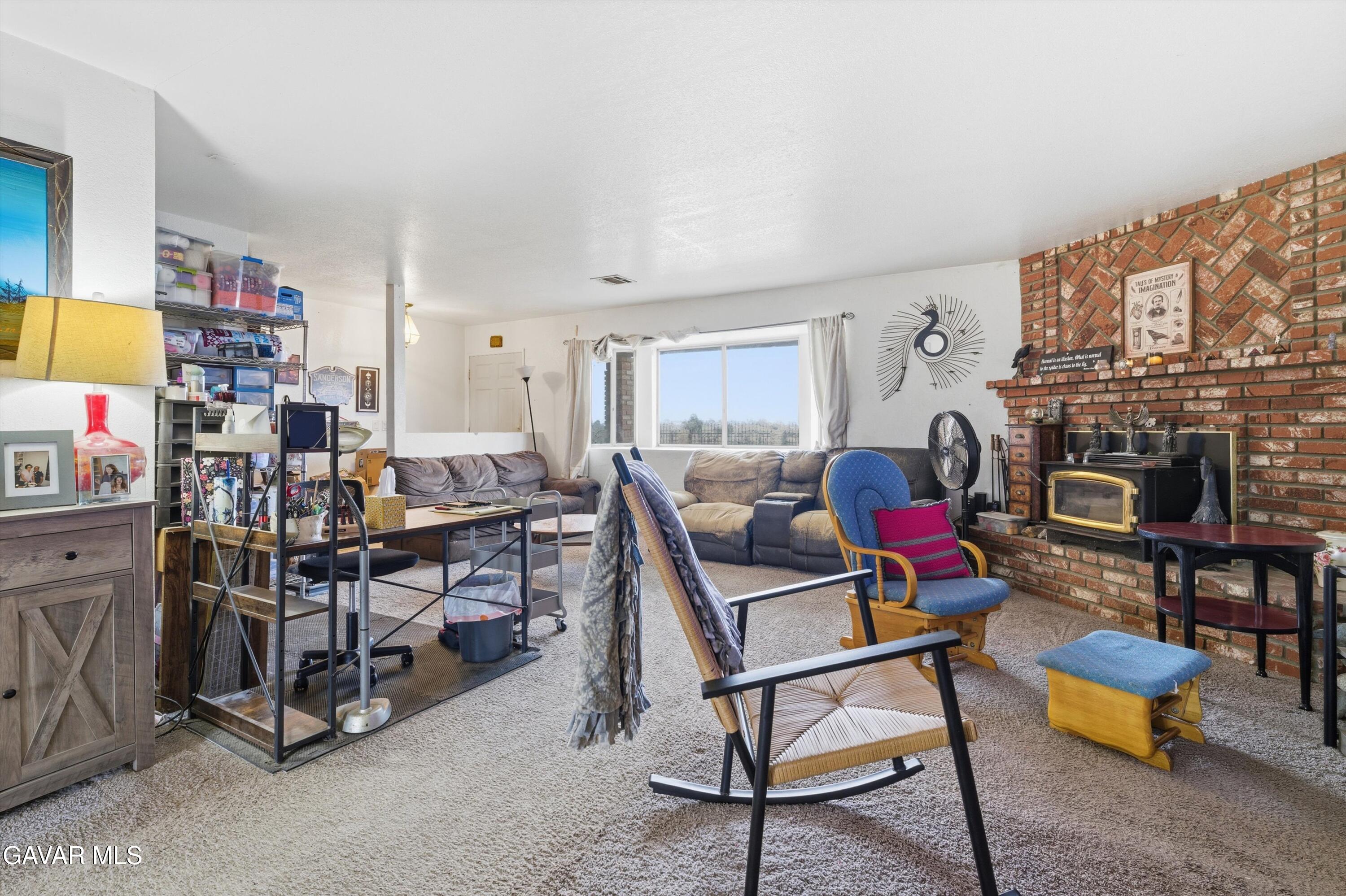 9340 East Ave R 10 Littlerock, CA 93543 - Photo 3 of 33 a living room with furniture and a fireplace