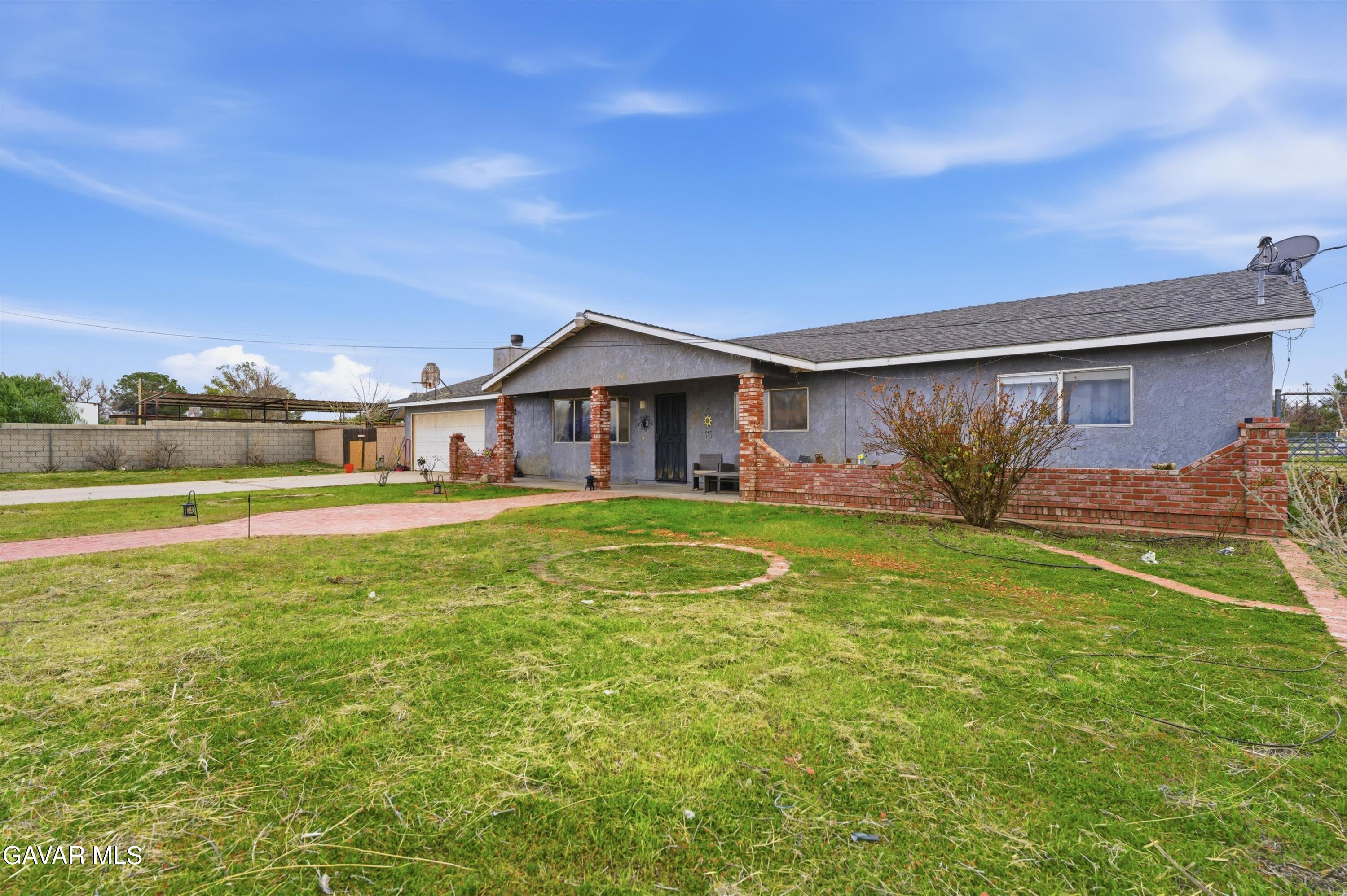 9340 East Ave R 10 Littlerock, CA 93543 - Photo 32 of 33 a front view of a house with garden