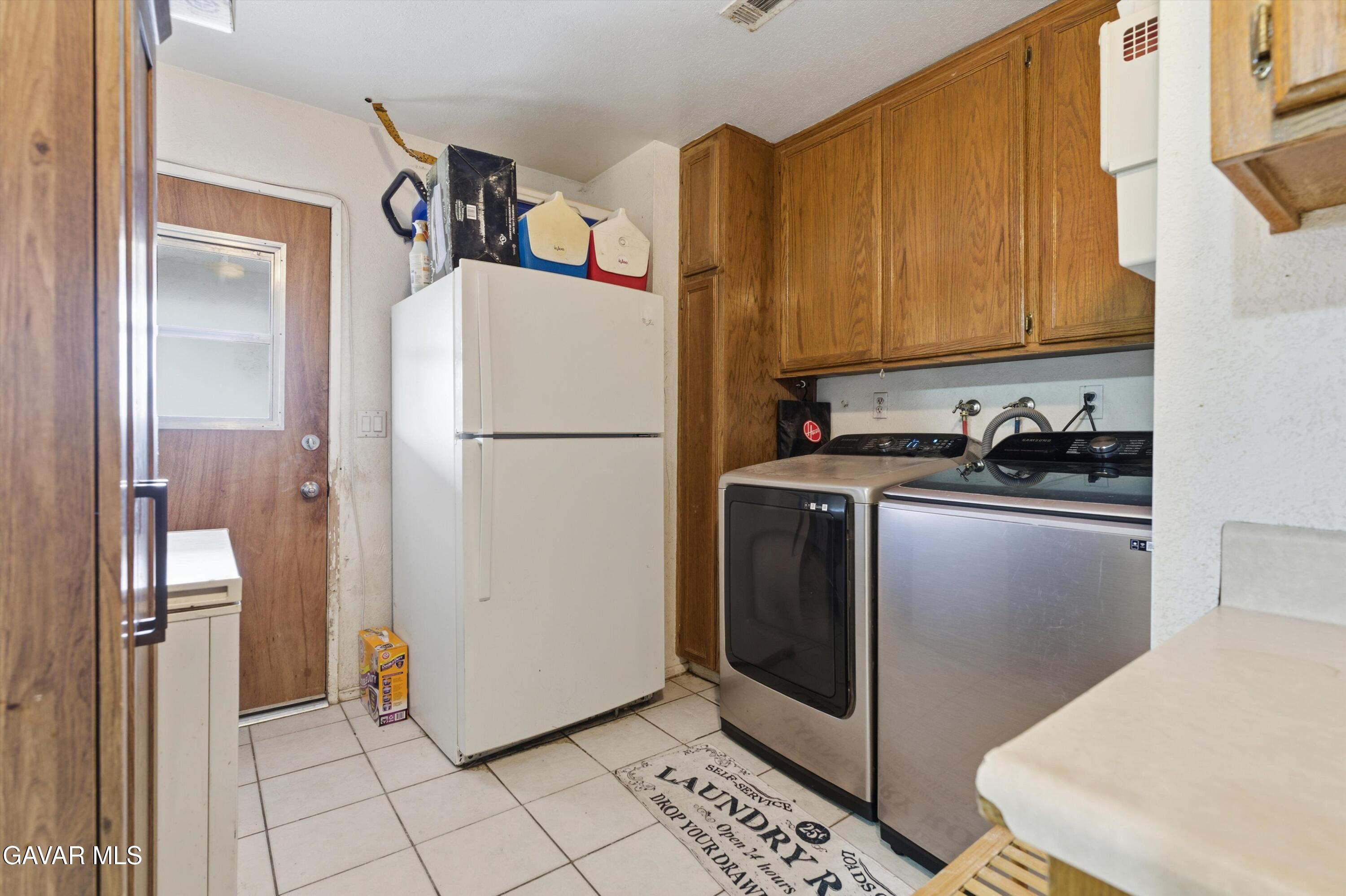 9340 East Ave R 10 Littlerock, CA 93543 - Photo 8 of 33 a white refrigerator freezer and a stove sitting inside of a kitchen