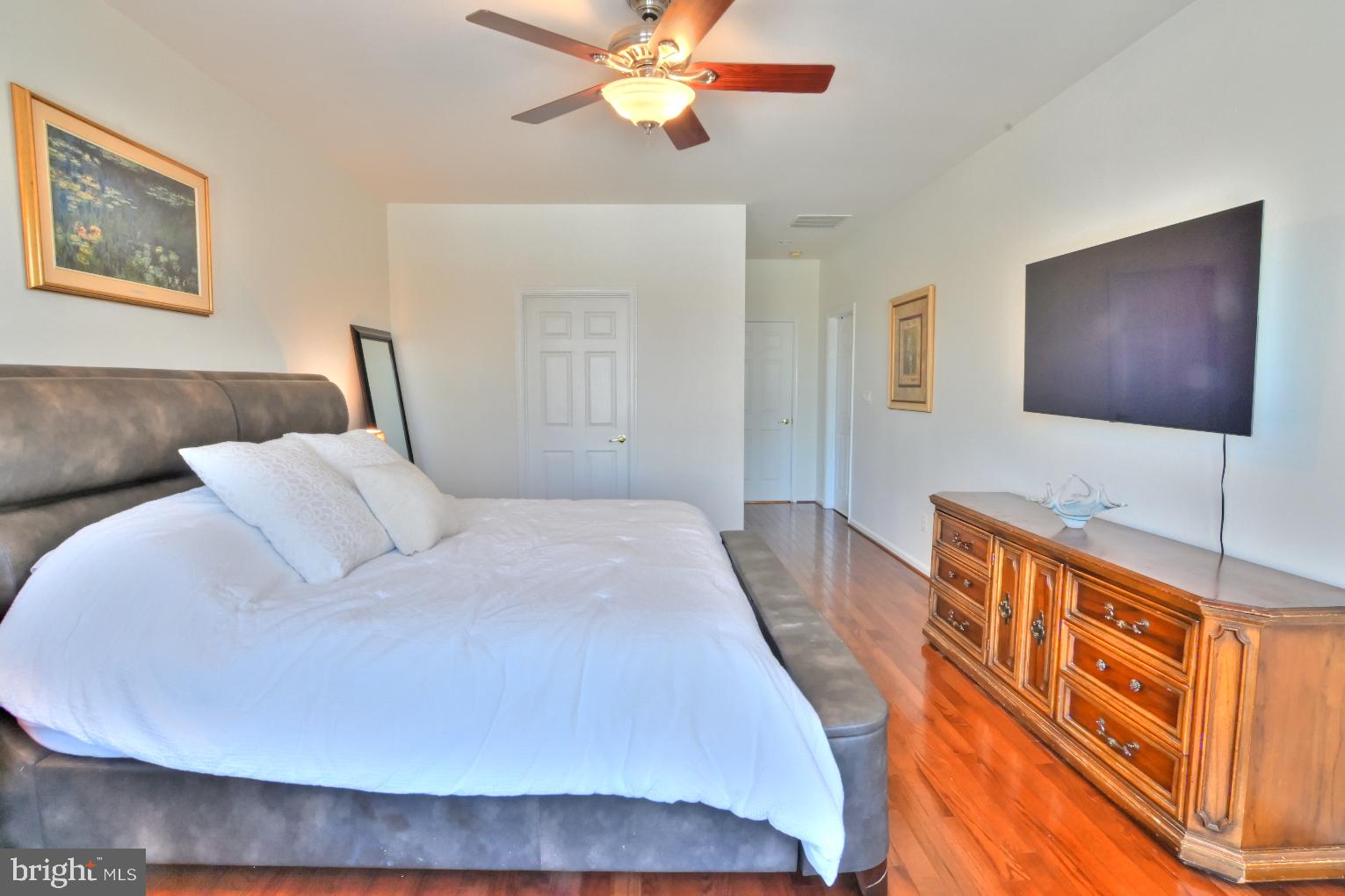 13170 Triple Crown Loop Gainesville, VA 20155 - Photo 35 of 71 a bed room with a bed and a chandelier