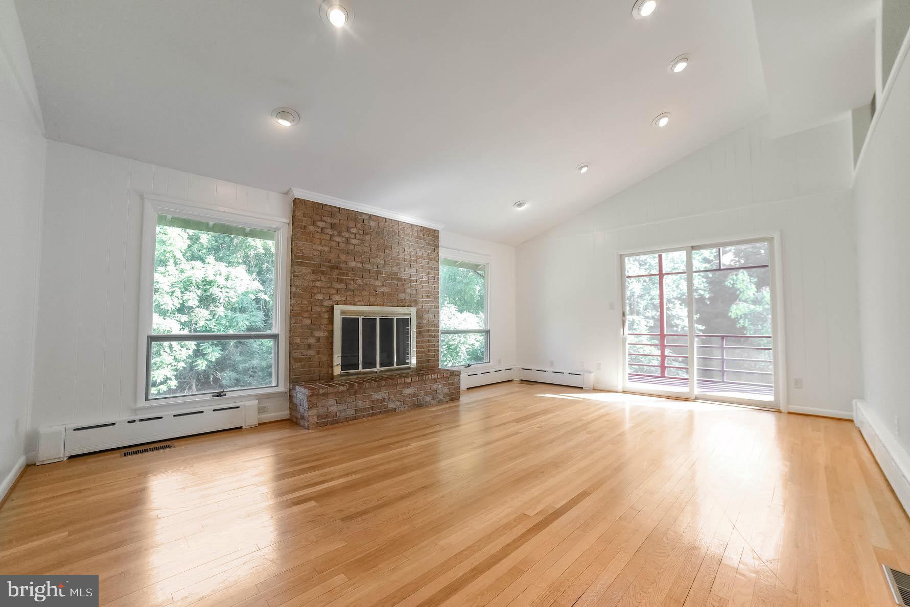 3444 Atropa Road Port Republic, MD 20676 - Photo 3 of 76 Wood fireplace is surrounded by wood floors.
