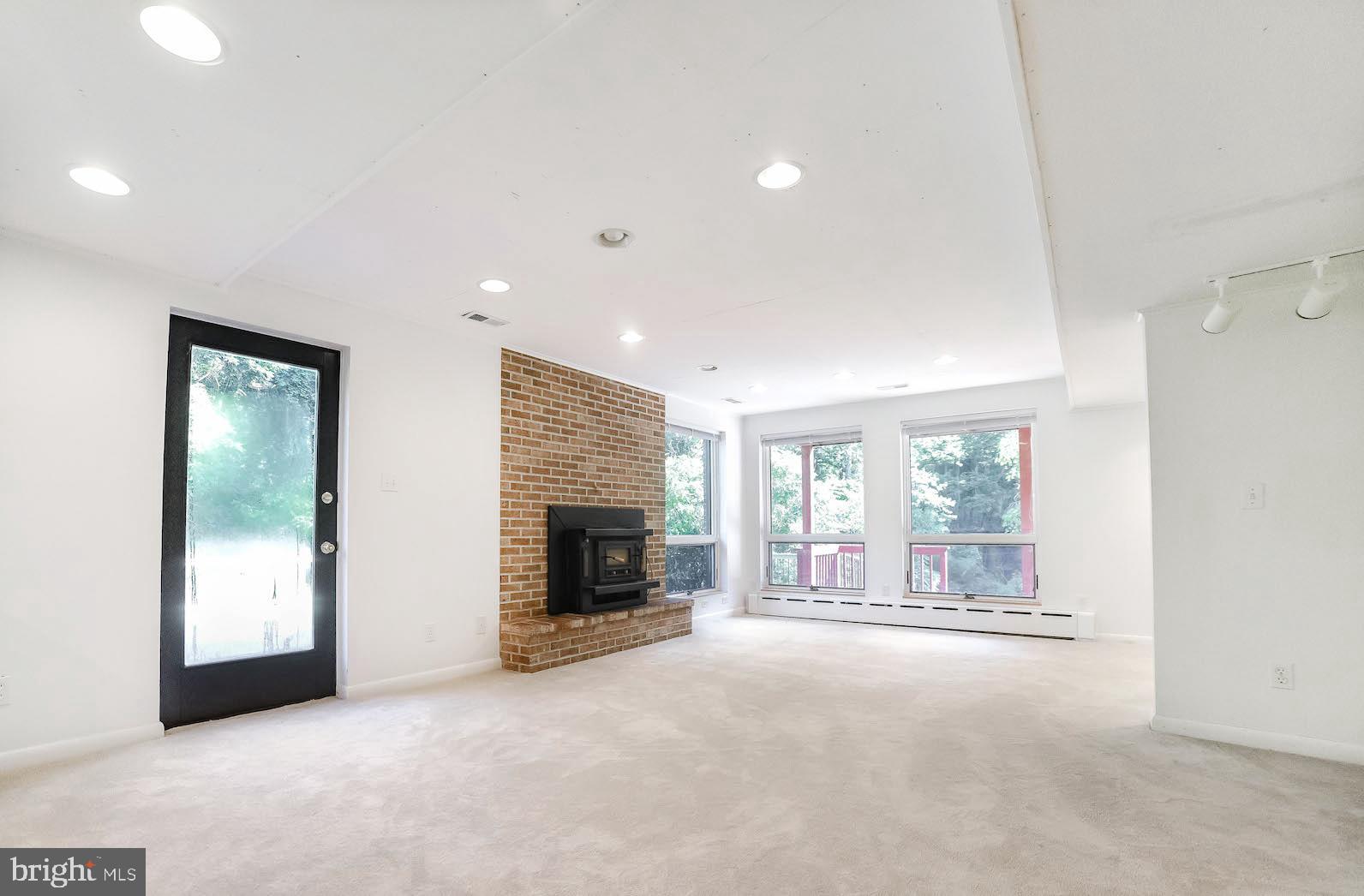 3444 Atropa Road Port Republic, MD 20676 - Photo 37 of 76 Bright and roomy lower level will wood stove