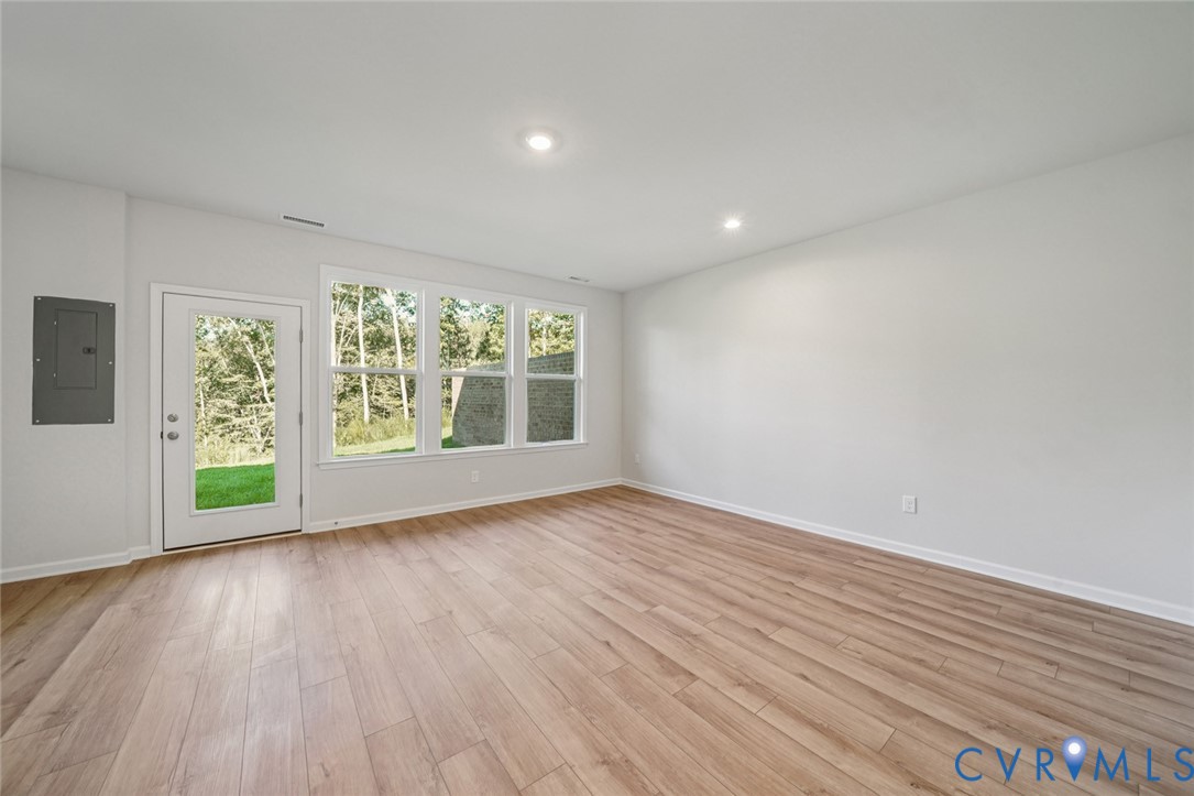 340 Mt Mccauley Way Aylett, VA 23009 - Photo 19 of 48 a view of an empty room with wooden floor and a window