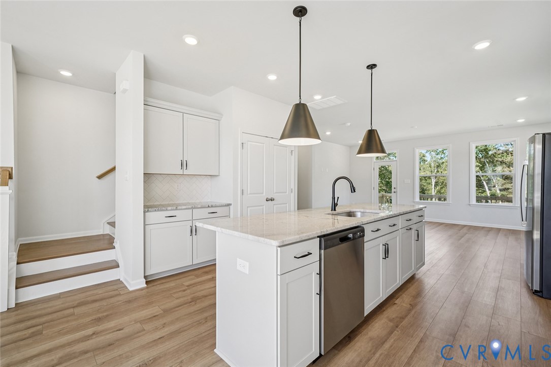 340 Mt Mccauley Way Aylett, VA 23009 - Photo 5 of 48 a kitchen with stainless steel appliances granite countertop a sink a stove and a wooden floor