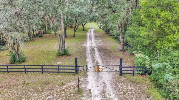 a view of a yard with wooden fence