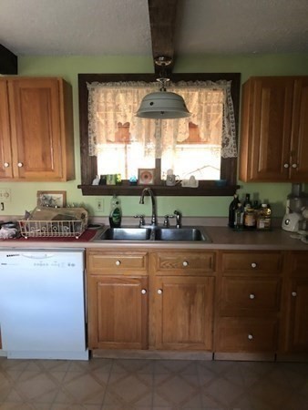 218 Granby Road Chicopee, MA 01013 - Photo 21 of 21 a kitchen with stainless steel appliances granite countertop a stove a sink and a microwave