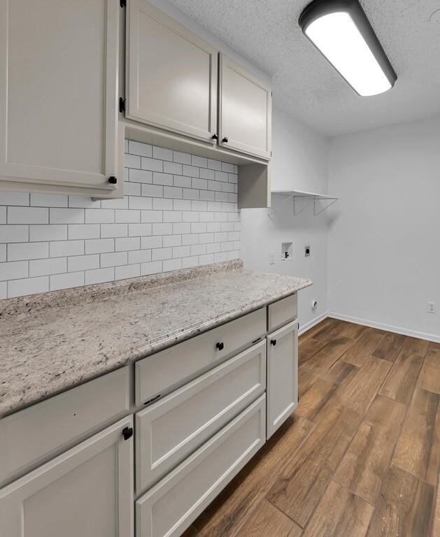 216 Texas Avenue Hewitt, TX 76643 - Photo 11 of 32 a kitchen with granite countertop white cabinets and a sink