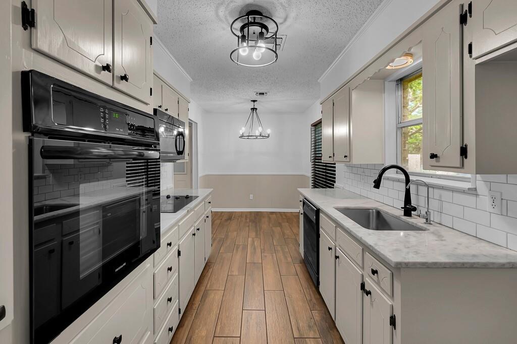 216 Texas Avenue Hewitt, TX 76643 - Photo 12 of 32 a kitchen with stainless steel appliances granite countertop a sink and stove