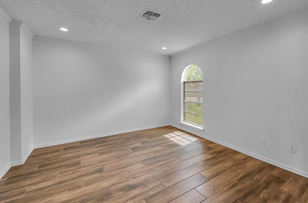 216 Texas Avenue Hewitt, TX 76643 - Photo 13 of 32 a view of empty room with wooden floor and fan