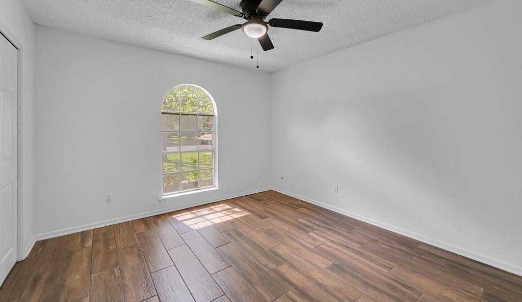 216 Texas Avenue Hewitt, TX 76643 - Photo 20 of 32 a view of empty room with wooden floor and fan