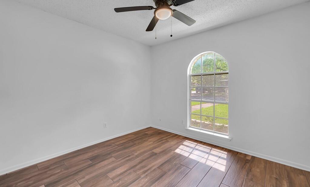 216 Texas Avenue Hewitt, TX 76643 - Photo 23 of 32 wooden floor in an empty room with a window