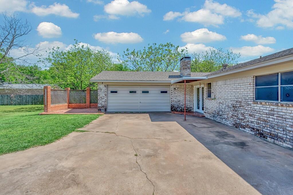 216 Texas Avenue Hewitt, TX 76643 - Photo 27 of 32 a view of a house with a yard and a garage