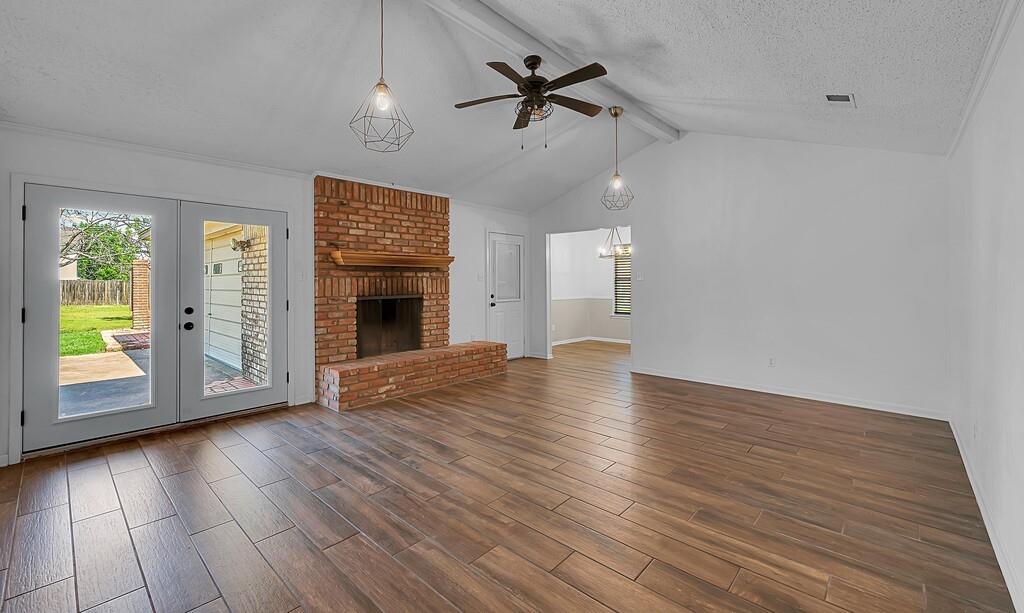 216 Texas Avenue Hewitt, TX 76643 - Photo 3 of 32 an empty room with wooden floor fan and windows