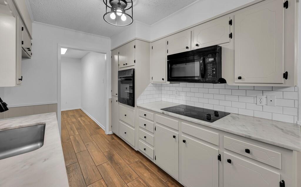 216 Texas Avenue Hewitt, TX 76643 - Photo 9 of 32 a kitchen with stainless steel appliances white cabinets and a sink
