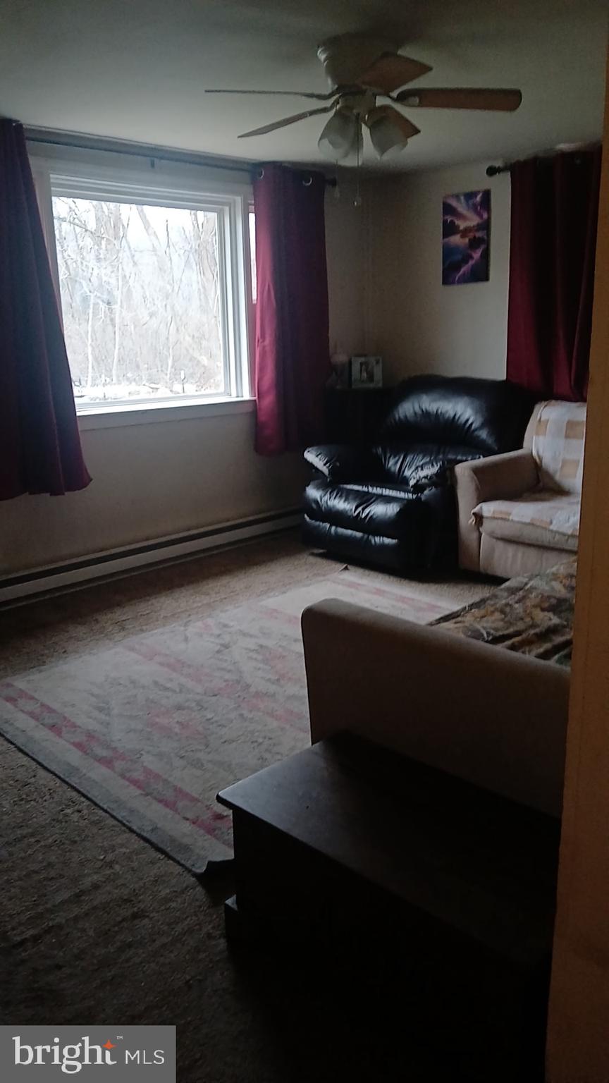 1934 Edgewood Road Chambersburg, PA 17202 - Photo 3 of 8 a living room with furniture rug and a window
