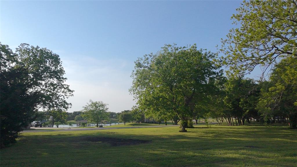 Lot 71 Shoreline Road Kerens, TX 75144 - Photo 12 of 24 a big yard with trees in the background