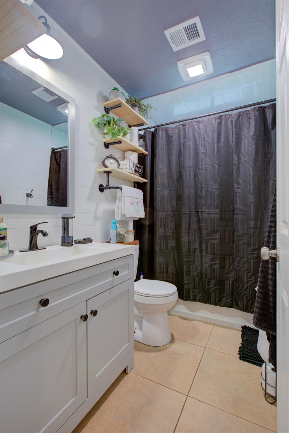 7139 Center Street Winton, CA 95388 - Photo 25 of 36 a bathroom with a sink a toilet a vanity and mirror