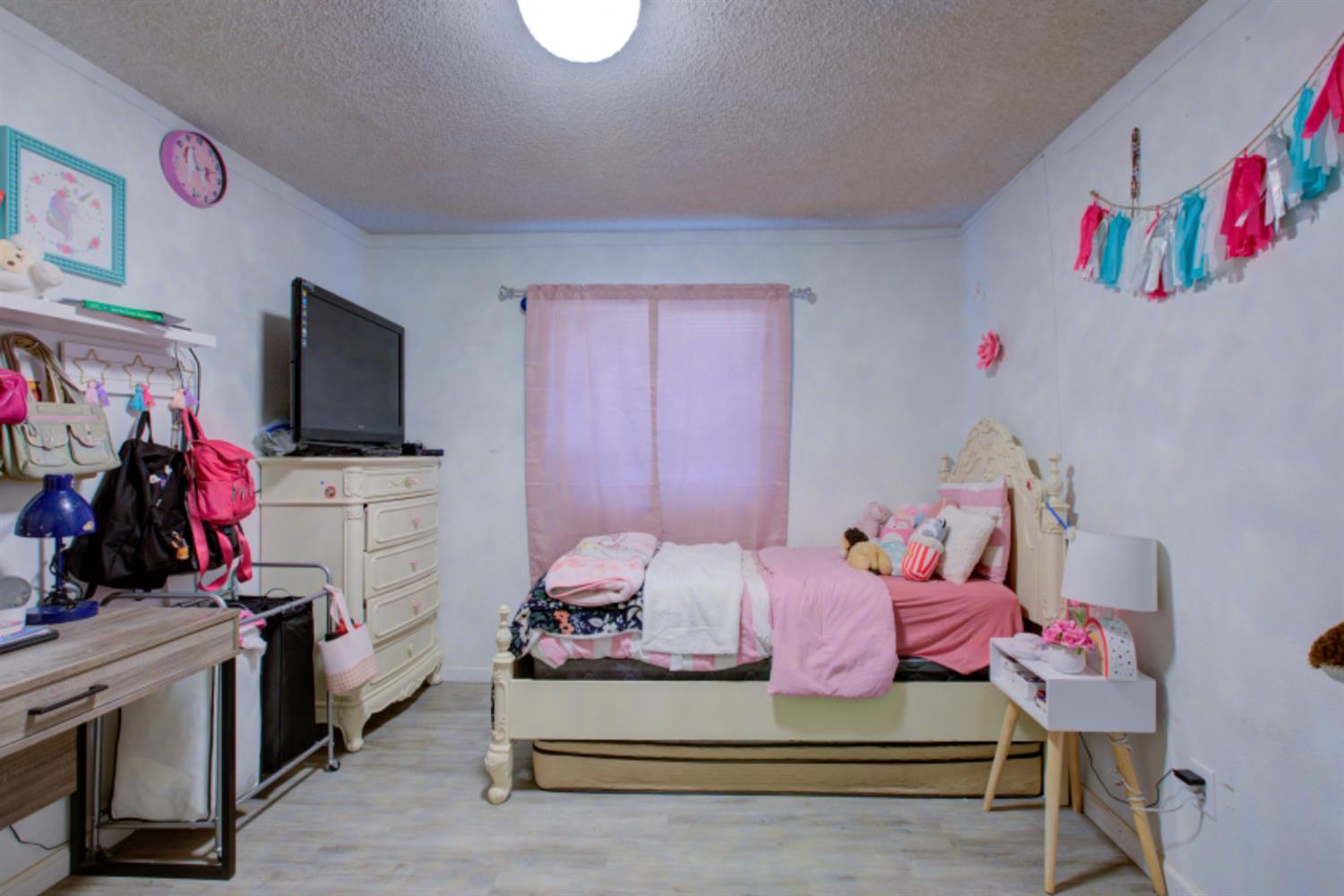 7139 Center Street Winton, CA 95388 - Photo 28 of 36 a bedroom with furniture and a flat screen tv