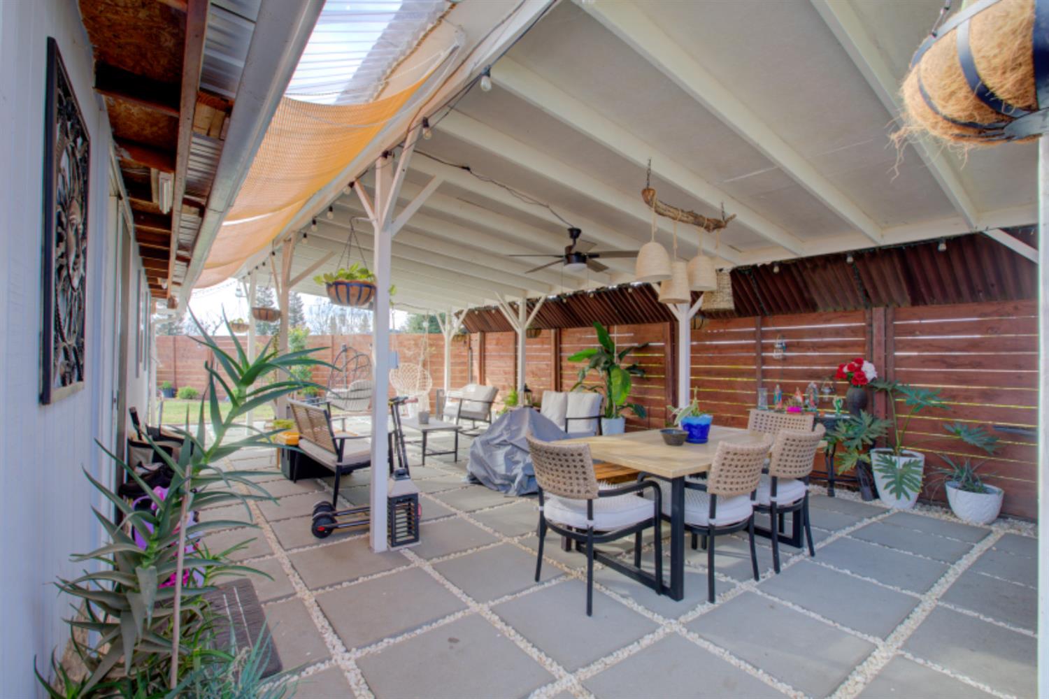 7139 Center Street Winton, CA 95388 - Photo 31 of 36 a view of a patio with a table and chairs and potted plants