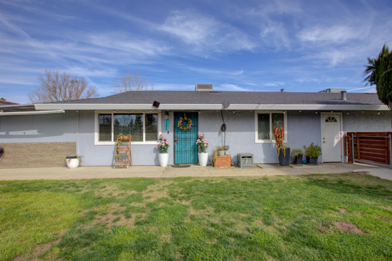 7139 Center Street Winton, CA 95388 - Photo 5 of 36 a front view of a house with a garden and porch