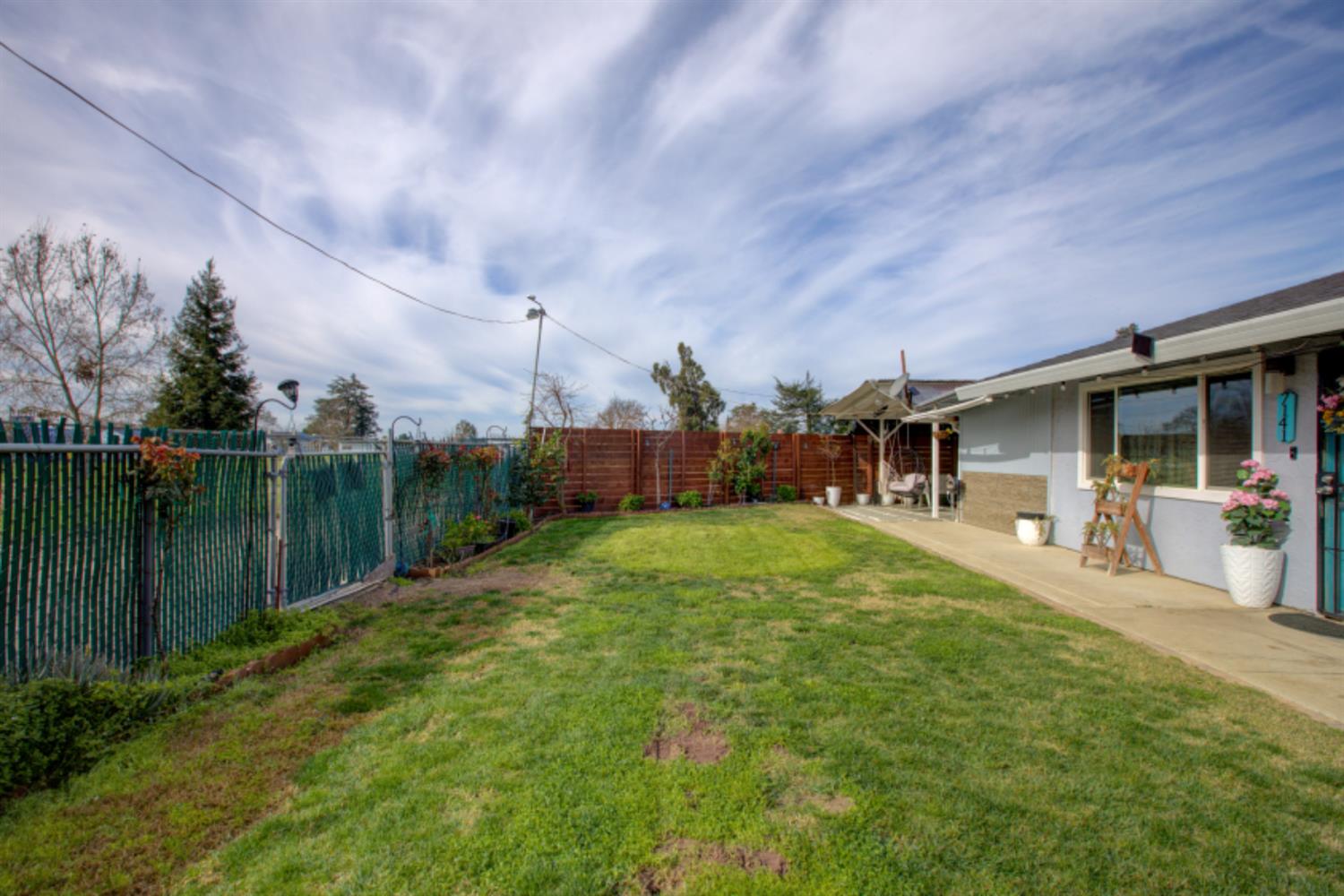 7139 Center Street Winton, CA 95388 - Photo 6 of 36 a front view of a house with a yard table and chairs