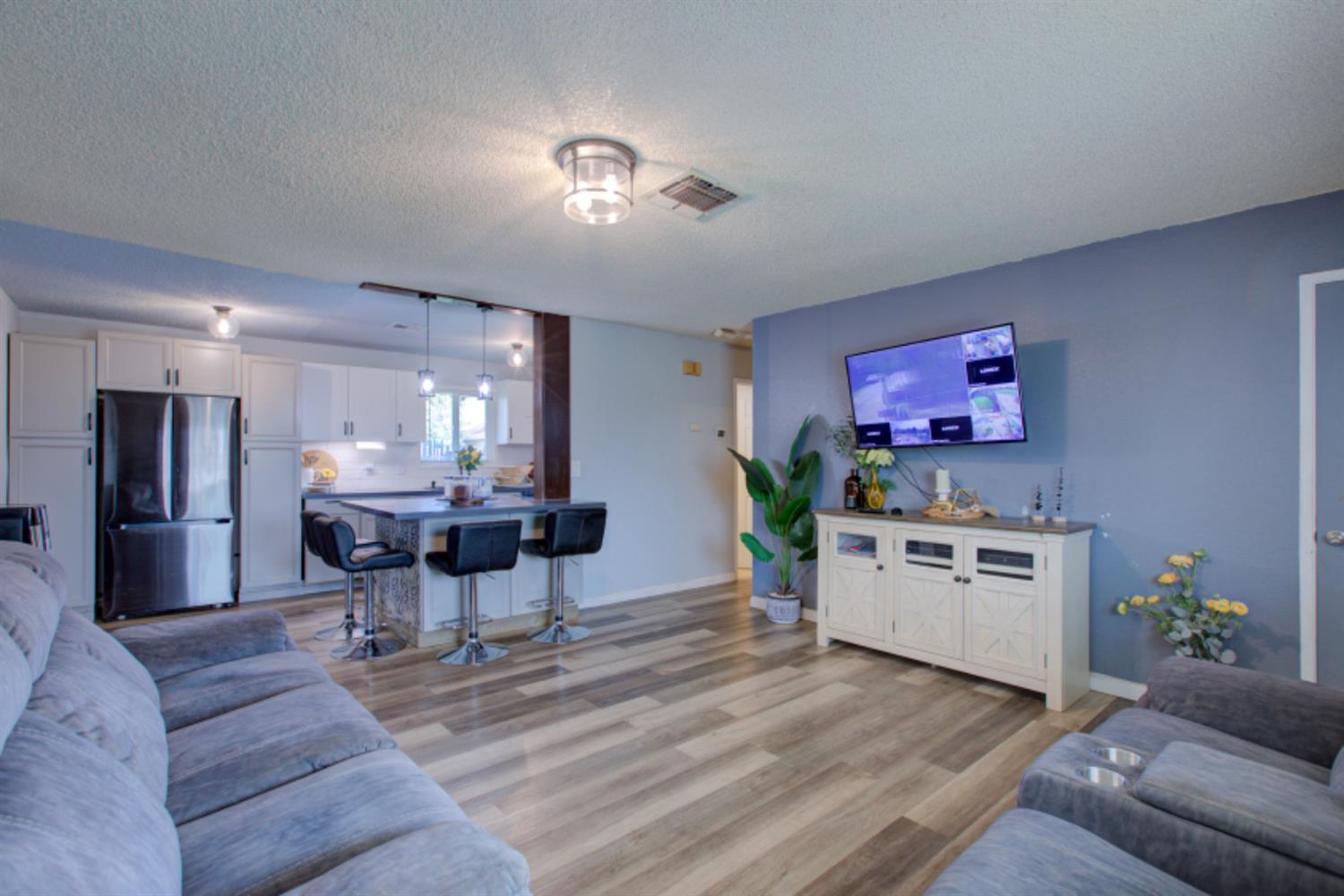 7139 Center Street Winton, CA 95388 - Photo 9 of 36 a living room with furniture and a dining table with kitchen view