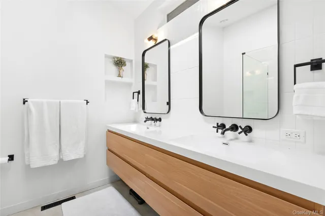 a bathroom with a double vanity sink mirror and